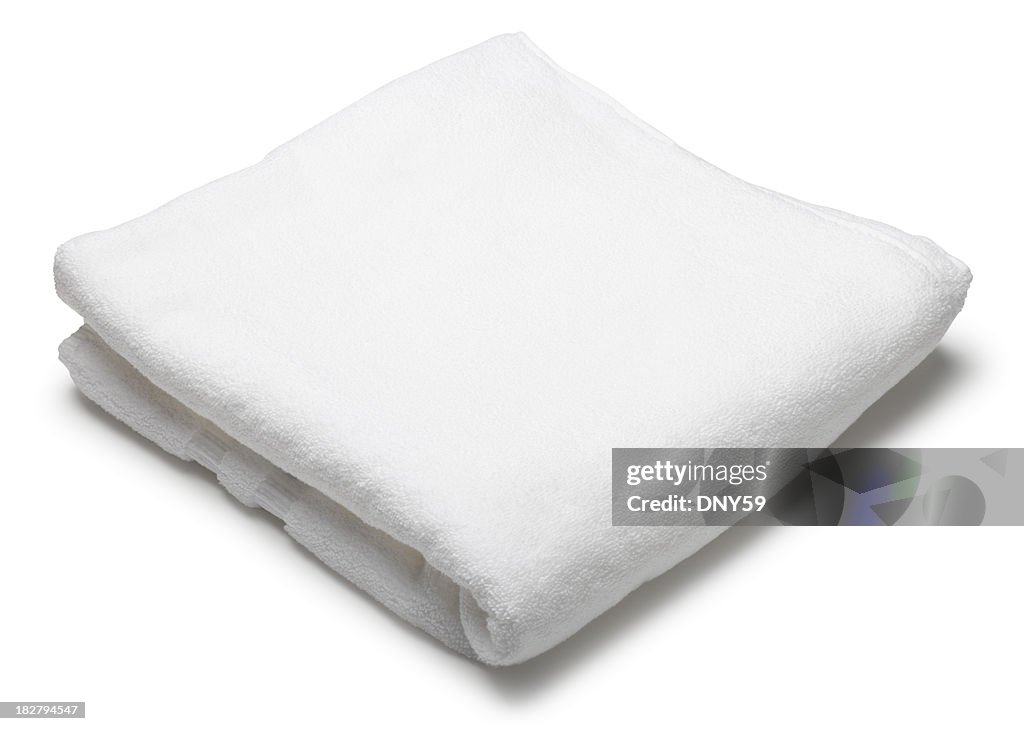 Folded white terrycloth towel on white background