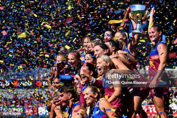 The Lions pose with the Premiership Trophy during the AFLW Grand Final match between North Melbourne Tasmania Kangaroos and Brisbane Lions at Ikon...