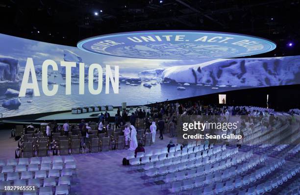 Participants arrive at the Health Day Opening Session at Al Waha Theatre under a digital projection of ice on day four of the UNFCCC COP28 Climate...