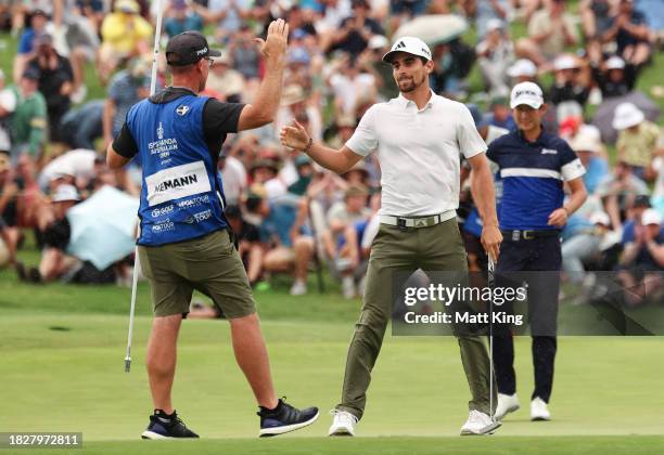 Joaquin Niemann of Chile celebrates winning the Men's ISPS HANDA Australian Open with his caddie during the 2nd playoff hole against Rikuya Hoshino...