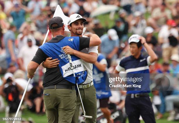 Joaquin Niemann of Chile celebrates winning the Men's ISPS HANDA Australian Open with his caddie during the 2nd playoff hole against Rikuya Hoshino...