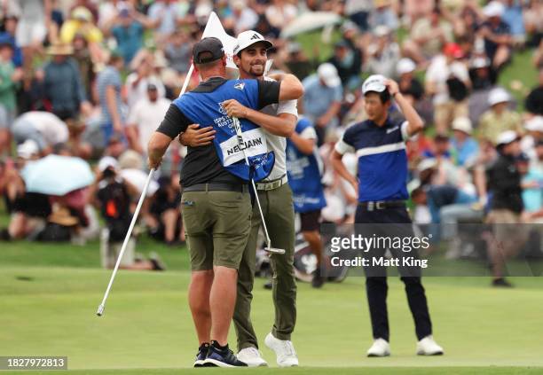 Joaquin Niemann of Chile celebrates winning the Men's ISPS HANDA Australian Open with his caddie during the 2nd playoff hole against Rikuya Hoshino...
