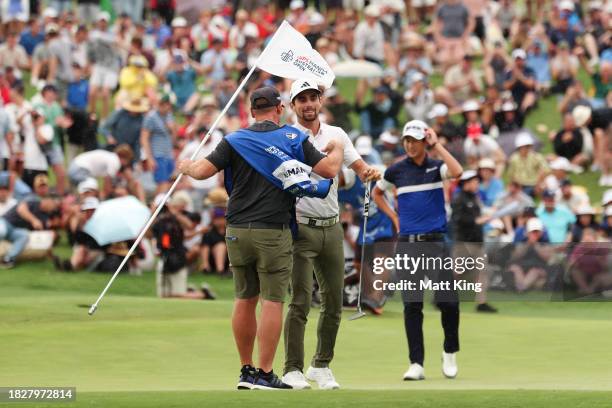 Joaquin Niemann of Chile celebrates winning the Men's ISPS HANDA Australian Open with his caddie during the 2nd playoff hole against Rikuya Hoshino...