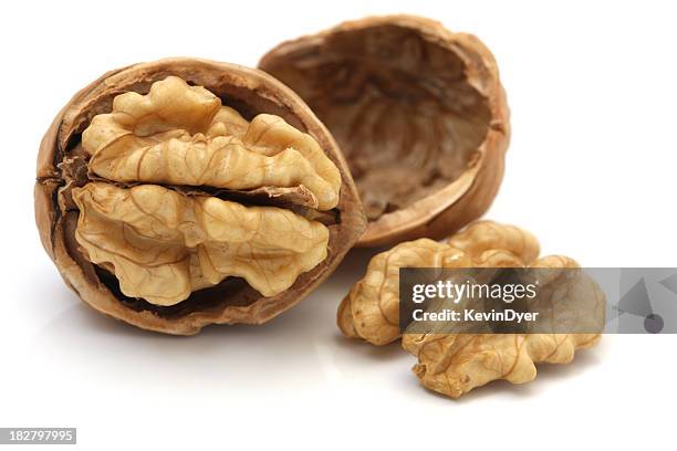 walnuts isolated on white background - walnuts stockfoto's en -beelden