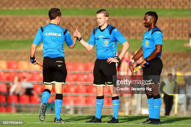 Referees and officials exchange pleasantries at full time after the A-League Men round six match between Newcastle Jets and Melbourne City at...