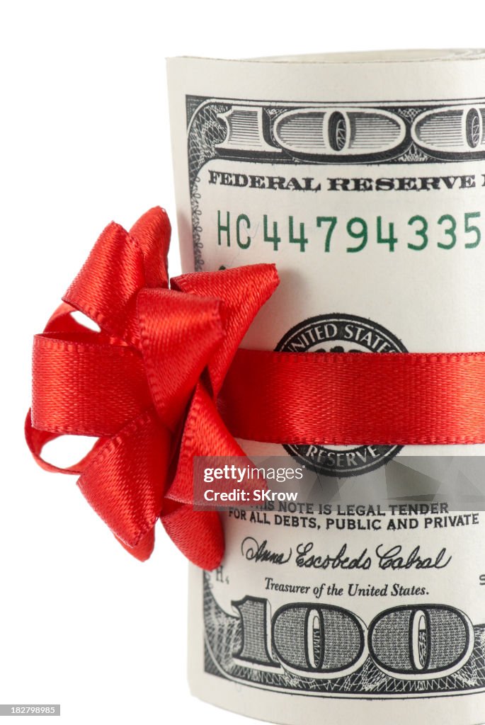 Wad of 100-dollar bills with red ribbon and bow