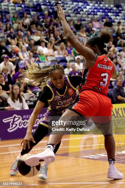 Jordin Canada of the Boomers handles the ball against Aari McDonald of the Lynx during the WNBL match between Melbourne Boomers and Perth Lynx at...