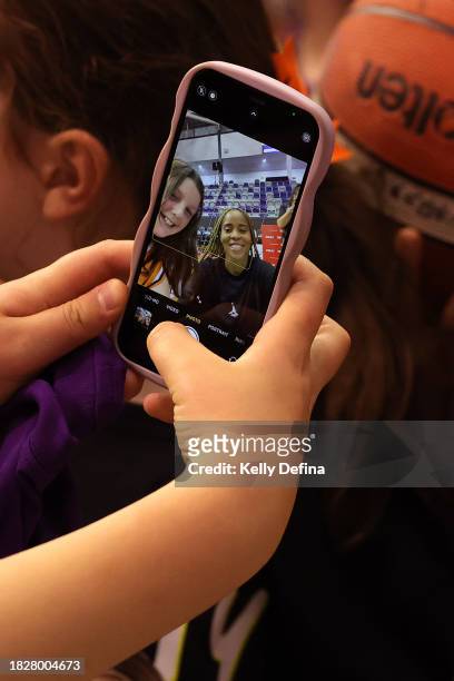Jordin Canada of the Boomers takes a selfie with a fan during the WNBL match between Melbourne Boomers and Perth Lynx at Melbourne Sports Centres -...