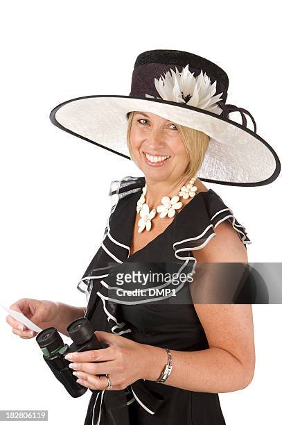 woman wearing hat, fashionably dressed, holding binoculars at the races - ladies day stock pictures, royalty-free photos & images