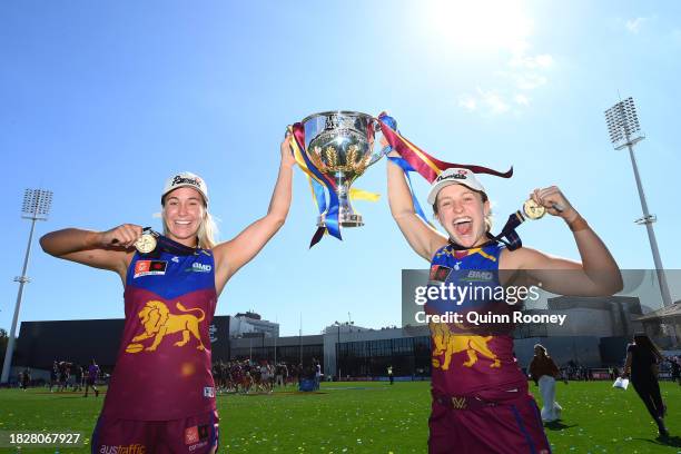 Natalie Grider and Isabel Dawes of the Lions celebrate with the Premiership Trophy during the AFLW Grand Final match between North Melbourne Tasmania...