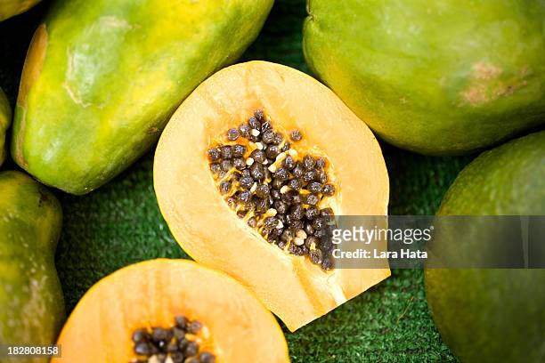 fresh papaya cut in half with seeds inside - enzyme structure stock pictures, royalty-free photos & images
