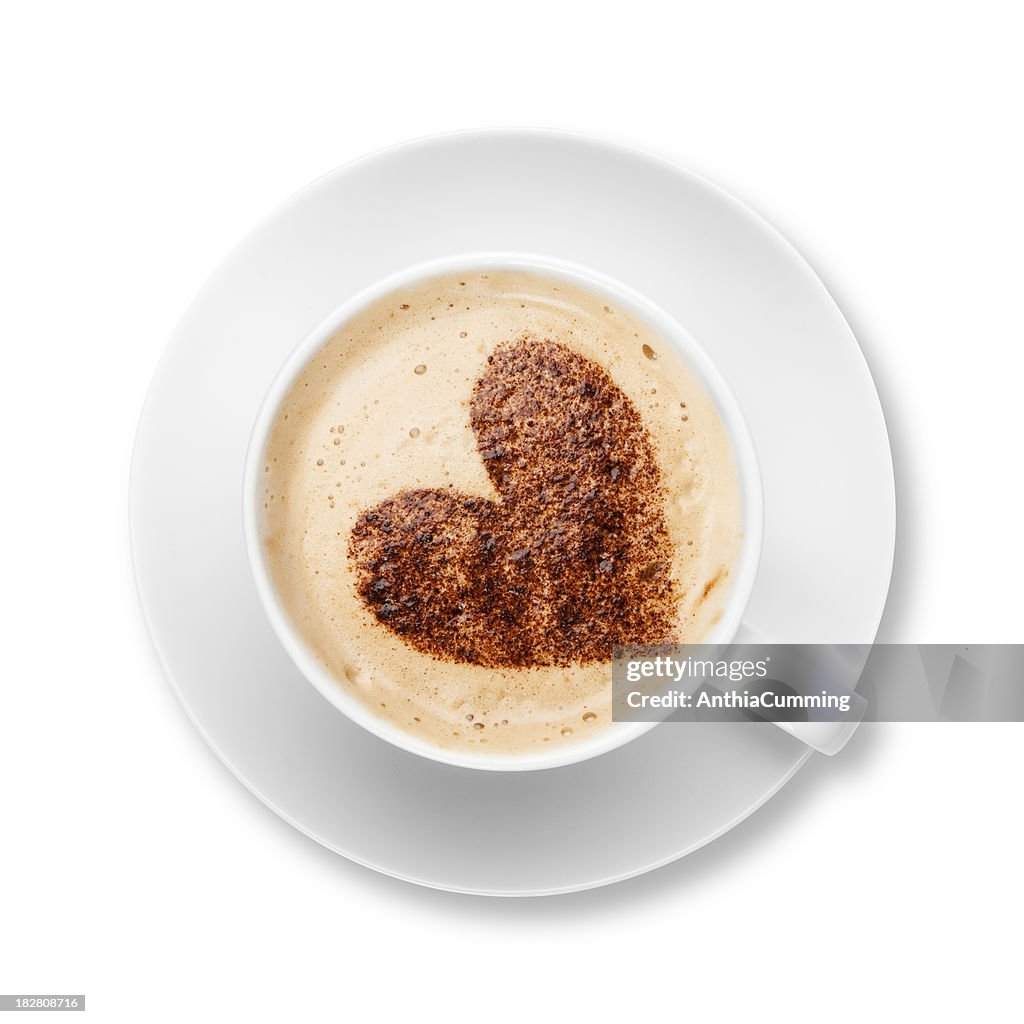 Cappuccino in white cup and saucer with chocolate heart