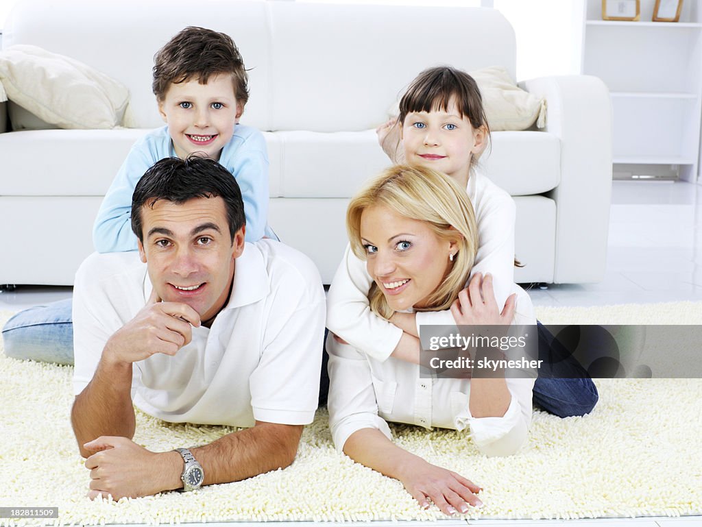 Heureuse famille Allongé sur le tapis.