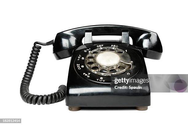 a black vintage rotary dial telephone - telefoon met kiesschijf stockfoto's en -beelden
