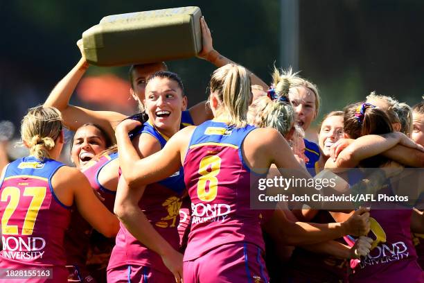 The Lions celebrate winning the AFLW Grand Final match between North Melbourne Tasmania Kangaroos and Brisbane Lions at Ikon Park, on December 03 in...