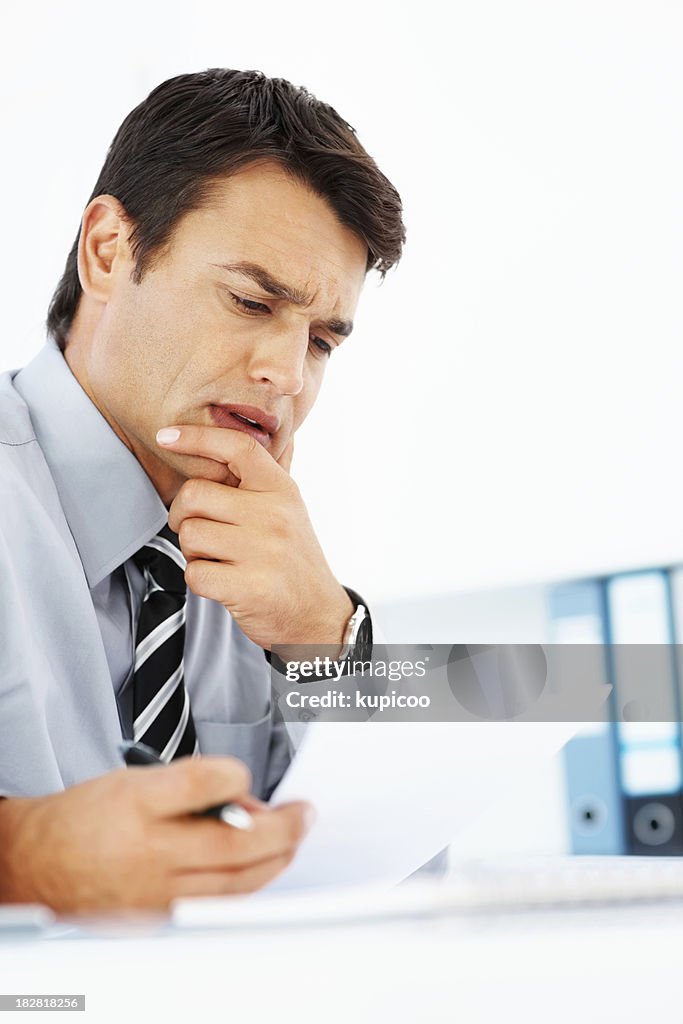 Confused business man reading a document