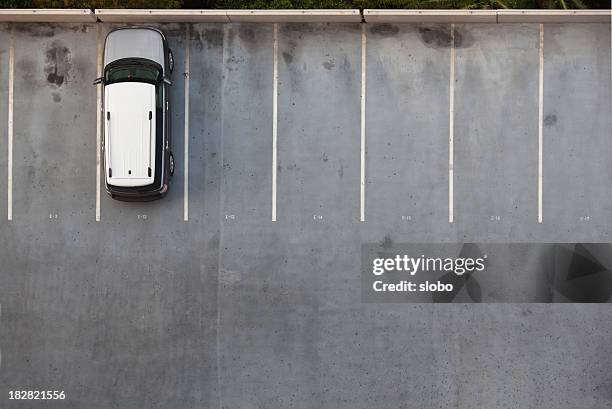 single car on a parking lot - parking lot stockfoto's en -beelden