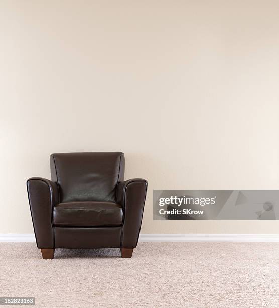 dark brown leather chair - beige carpet stock pictures, royalty-free photos & images