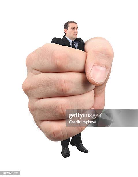 businessman in giant hand - terrified man stock pictures, royalty-free photos & images