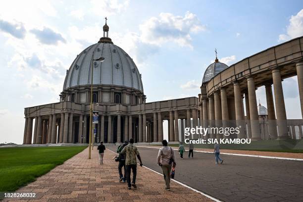 Journalists from the international press arrive for a visit of the "Notre Dame de la Paix" basilica, on the sidelines of the visit to the CAN 2024...
