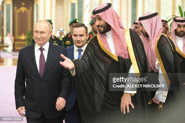 This pool photograph distributed by Russian state agency Sputnik shows Russia's President Vladimir Putin and Saudi Crown Prince Mohammed bin Salman...