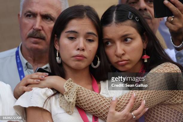 Two young women comfort one another while fellow activists read out the names of people killed in Gaza in the current Gaza conflict on day four of...