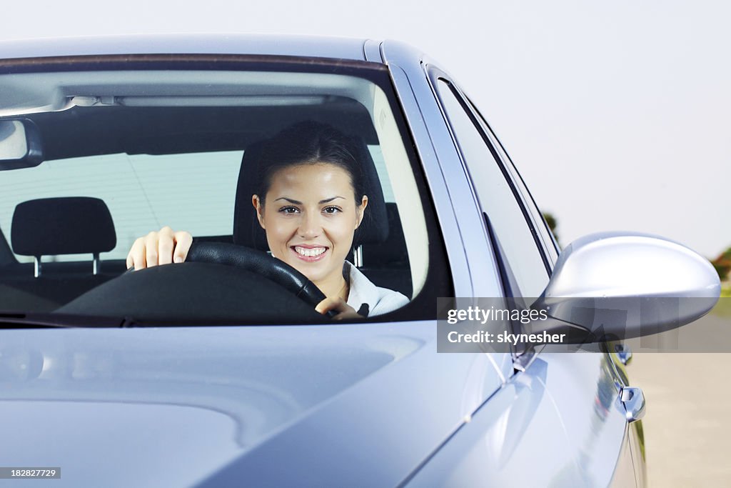 Portrait of beautiful woman drive a automobile.