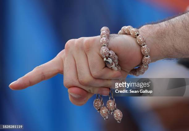 Pro-Palestinian activist with beads around his wrist speaks at a protest for a ceasefire in the Gaza conflict on day four of the UNFCCC COP28 Climate...