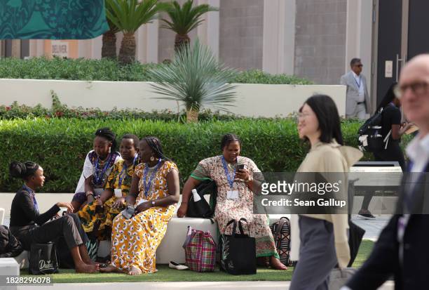 Women participants from Kenya take a break on day four of the UNFCCC COP28 Climate Conference at Expo City Dubai on December 03, 2023 in Dubai,...