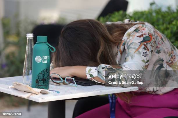 Participant takes a nap outside on day four of the UNFCCC COP28 Climate Conference at Expo City Dubai on December 03, 2023 in Dubai, United Arab...