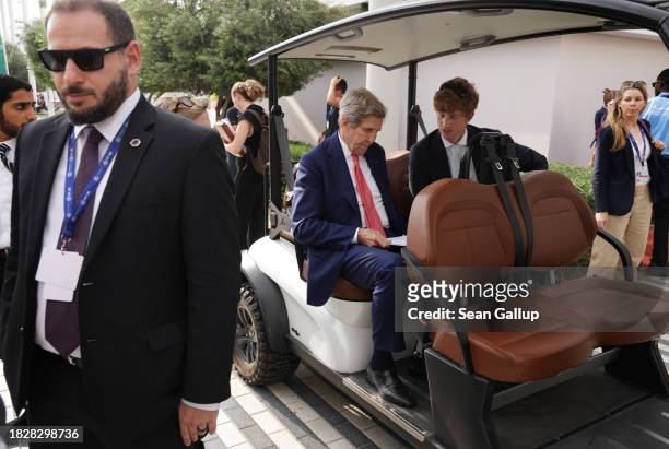 John Kerry , U.S. Special presidential envoy for climate, arrives in a golf cart for a meeting on day four of the UNFCCC COP28 Climate Conference at...