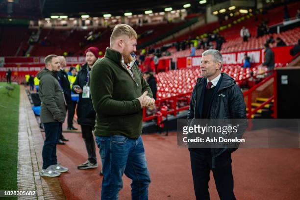 Kaleb Cooper reacts with Denis Irwin prior to the Premier League match between Manchester United and Chelsea FC at Old Trafford on December 6, 2023...