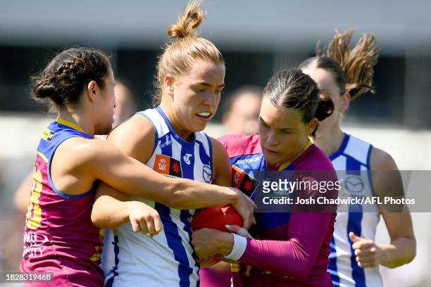 Mia King of the Kangaroos is tackled by Sophie Conway of the Lions during the AFLW Grand Final match between North Melbourne Tasmania Kangaroos and...