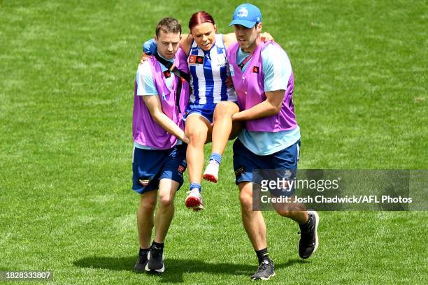Jenna Bruton of the Kangaroos leaves the field injured during the AFLW Grand Final match between North Melbourne Tasmania Kangaroos and Brisbane...
