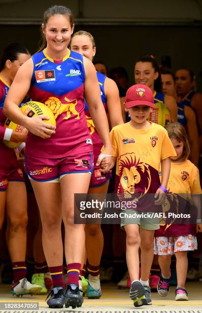Breanna Koenen of the Lions leads her team out onto the field during the AFLW Grand Final match between North Melbourne Tasmania Kangaroos and...