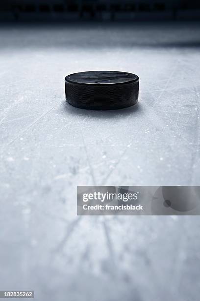 hockey puck on ice - hockey puck stock pictures, royalty-free photos & images