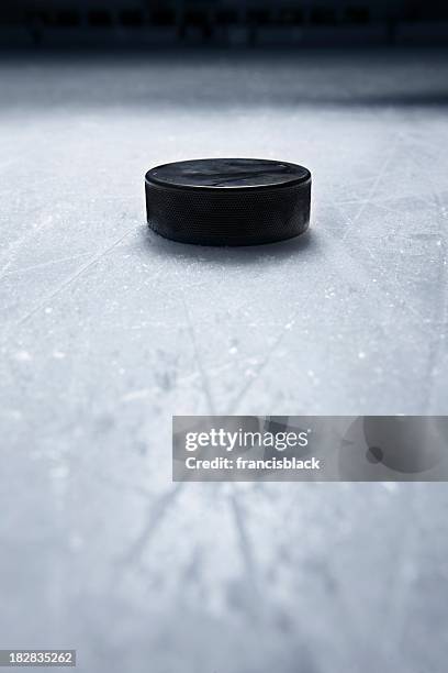 hockey puck on ice - hockey ice stock pictures, royalty-free photos & images