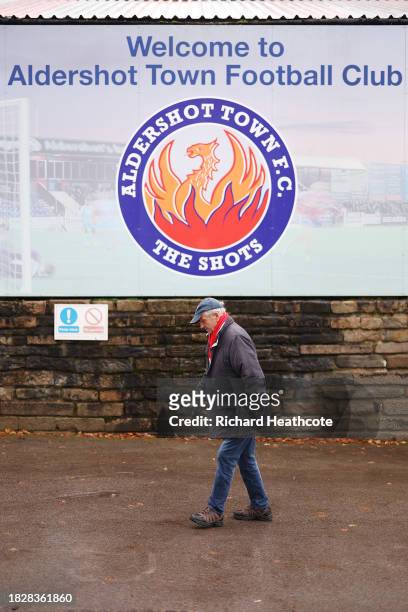 Detailed shot of a fan in front of the welcome sign prior to the Emirates FA Cup Second Round match between Aldershot Town and Stockport County at...