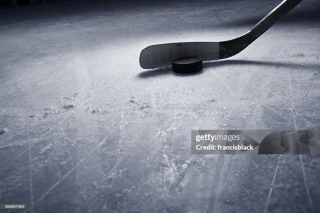 Hockey Stick and Puck on Ice