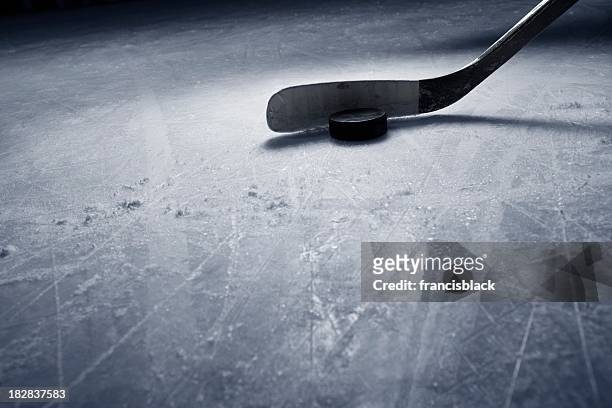hockey stick and puck on ice - ice hockey stock pictures, royalty-free photos & images