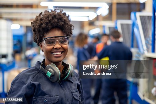Happy employee working at a solar panel factory Happy employee working at a solar panel factory