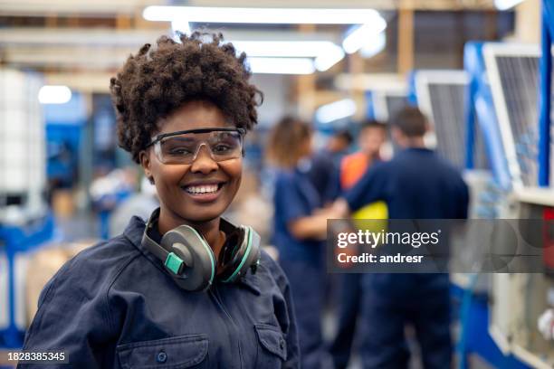 happy employee working at a solar panel factory - ear protection stock pictures, royalty-free photos & images