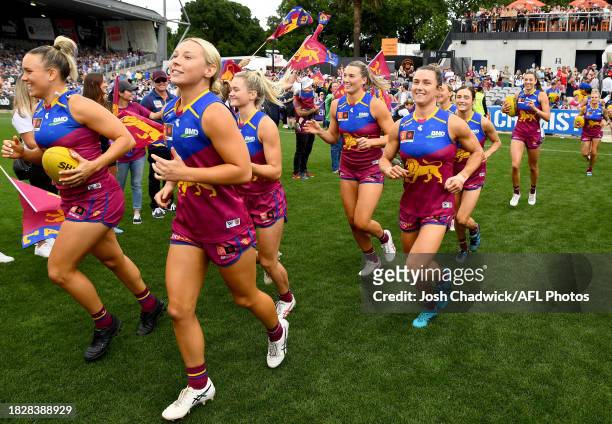 The Lions run out onto the field during the AFLW Grand Final match between North Melbourne Tasmania Kangaroos and Brisbane Lions at Ikon Park, on...