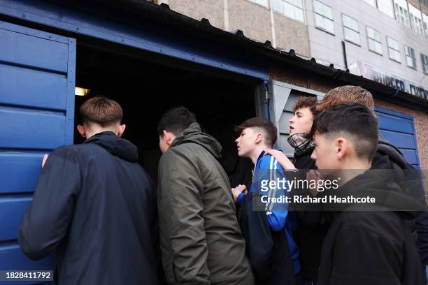 Fans are shown trying to watch the FA Cup Third Round in the groundmans hut prior to the Emirates FA Cup Second Round match between Aldershot Town...