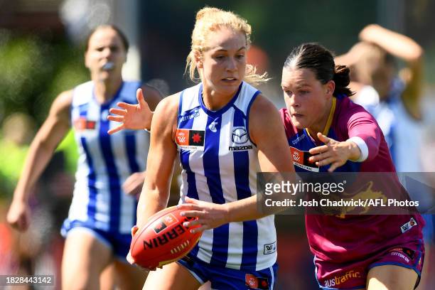 Lulu Pullar of the Kangaroos is tackled by Sophie Conway of the Lions during the AFLW Grand Final match between North Melbourne Tasmania Kangaroos...