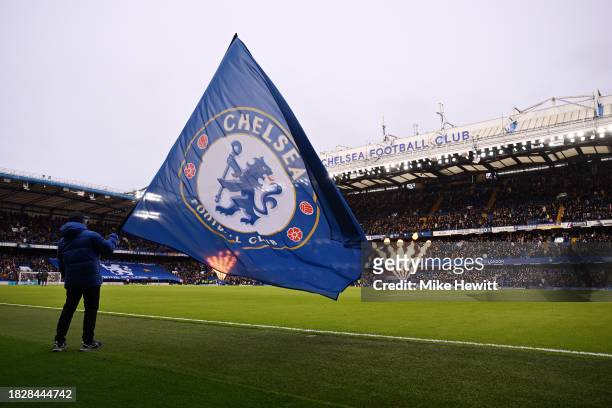 Flag bearer waves a Chelsea flag inside the stadium prior to the Premier League match between Chelsea FC and Brighton & Hove Albion at Stamford...