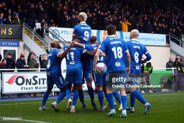 Paul McCallum of Eastleigh celebrates with teammates after scoring the team's first goal during the Emirates FA Cup Second Round match between...