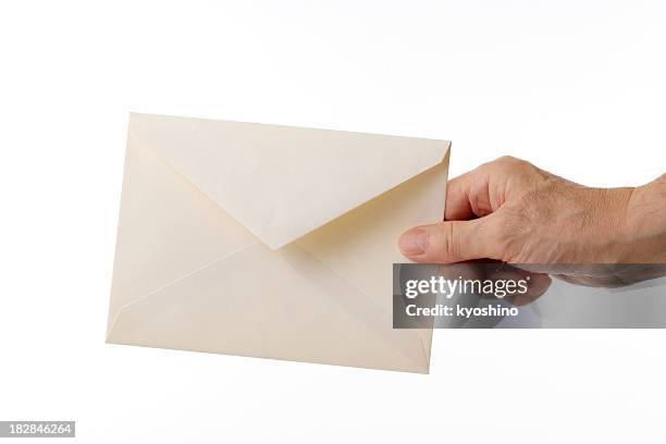isolated shot of holding an old envelope against white background - kuvert bildbanksfoton och bilder