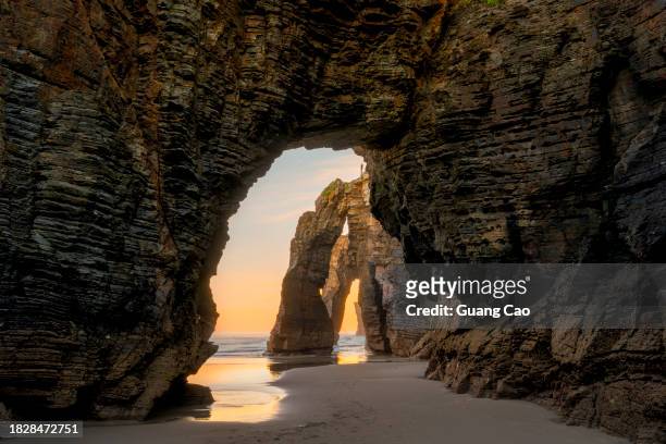 natural rock arches on cathedrals beach (playa de las catedrales), ribadeo, galicia, spain - rock formation on beach stock pictures, royalty-free photos & images