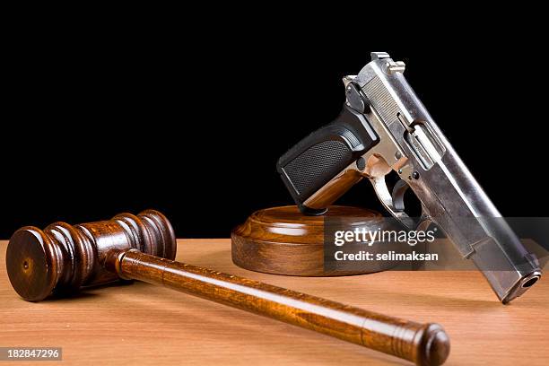 wooden gavel and handgun on table for crime punishment concept - guns stock pictures, royalty-free photos & images